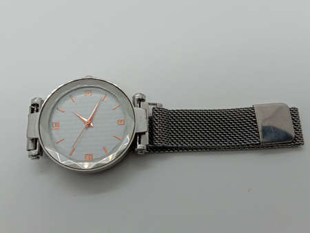 gray colored watch closeup on gray backgroundの写真素材