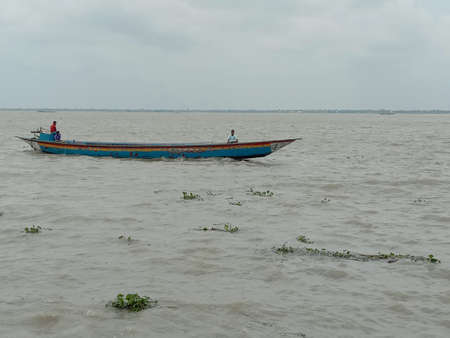 wooden fishing boat on river with skyの写真素材