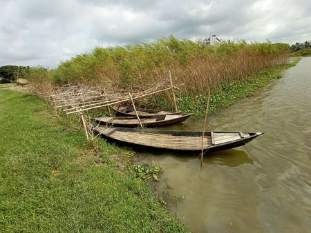 black colored wooden fishing boat on lakeの写真素材