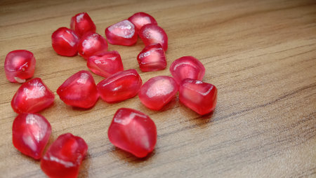 pomegranate seeds stock on wooden table