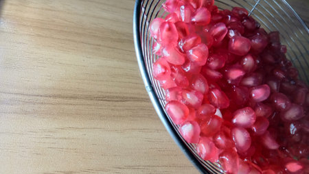 tasty and healthy pomegranate seeds stock on net spoon