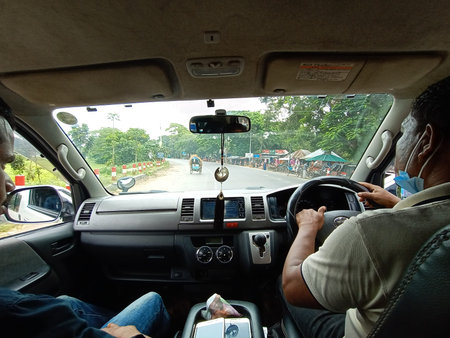 dashboard view of car with driver on road