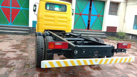 back side of yellow colored truck on road