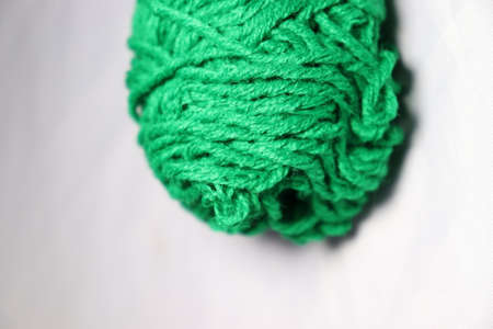 green colored yarn closeup on white backgroundの写真素材