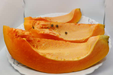 tasty and healthy colorful papaya cut peace closeupの写真素材
