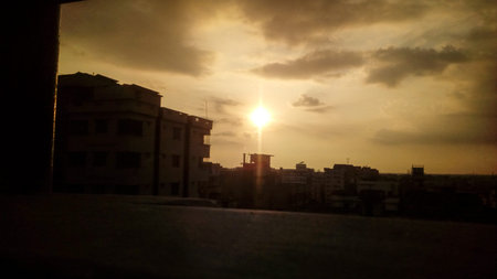 sun on orange sky and evening city view