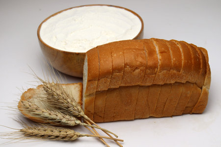 tasty and healthy bread and ripe wheat with atta on white background