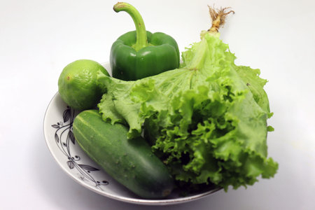 tasty and healthy green colored capsicum with cucumber and lemon and lettuce