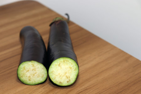 tasty and healthy violet colored Brinjal on wooden table for cooking