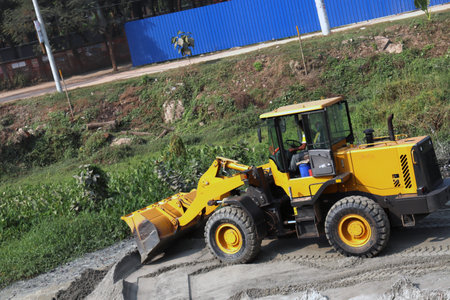 yellow colored hydraulic Construction Excavator on sand for move