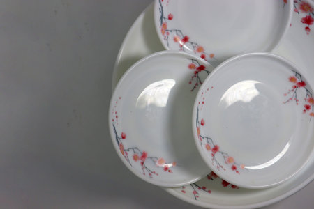 ceramic cup and plate closeup on white background