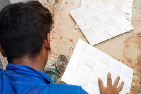 tile cutter machine with blade in house with workerの写真素材