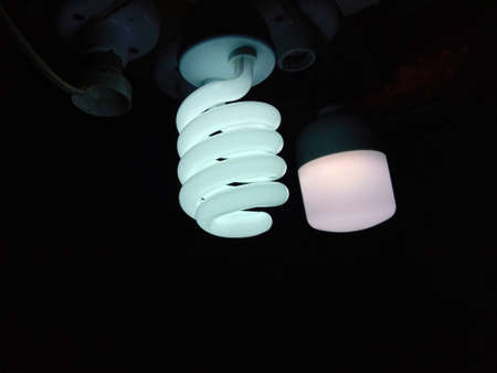 white colored energy bulb closeup on nightの写真素材