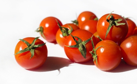 Ripe tomatoes on the white backgroundの写真素材