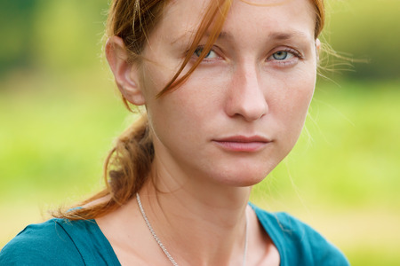 Serious young woman looking at cameraの写真素材