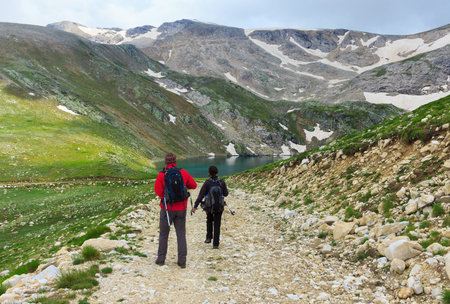 Couple of travelers walking on a trail in Uludag Mountains