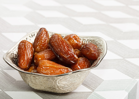 Beautiful bowl full of date fruits symbolizing Ramadanの写真素材