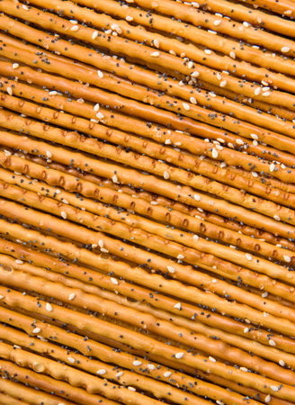 Pretzels with salt, sesame and poppy seeds, background texture