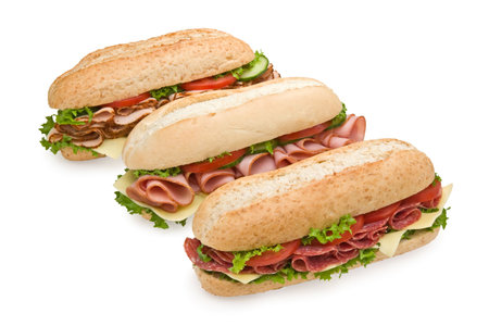 Trio of fresh submarine sandwiches on white background - salami, ham and turkeyの写真素材