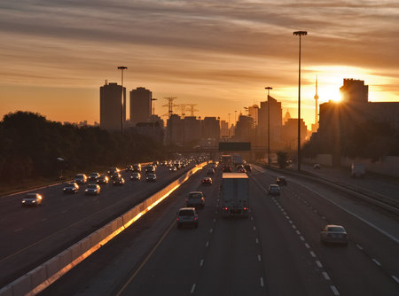 The beginning of morning rush hour, cars on the highway traveling to and from  downtown