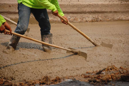 Builders pouring cementの写真素材