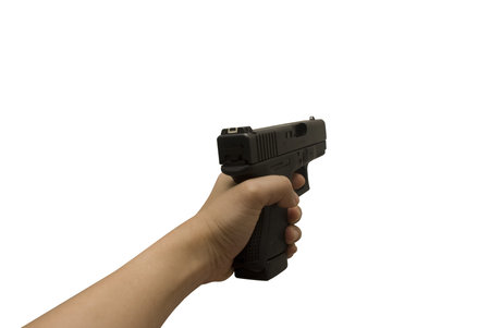 a girl holds a black handgun with left hand on white background