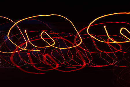 Neon lines on a black background. Long exposure photo taken in the studio.