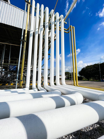 Industrial zone, Steel pipelines and valves on blue sky background.