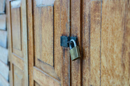 Old wooden door with metal key lock set.の写真素材