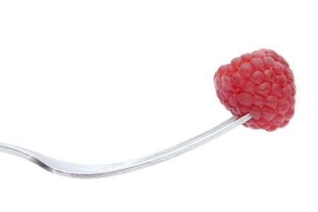 A raspberry on the end of a fork, landscape formatの写真素材
