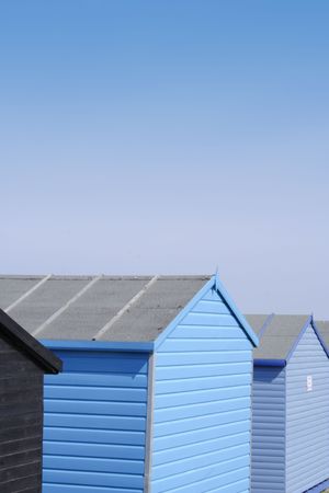Blue beach huts with a bright blue sky, portrait formatの写真素材