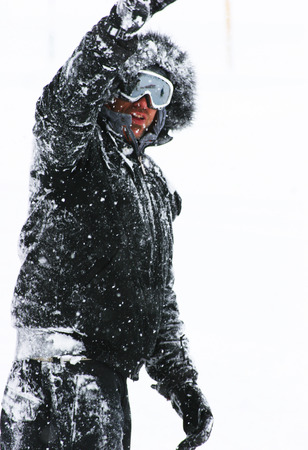man in black walking in the snowの写真素材