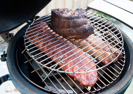 Pork shoulder and ribs on a grillの写真素材