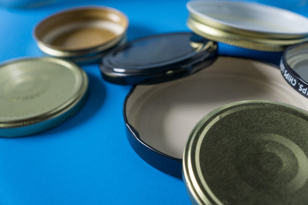 Recycling glass jar lids for reuse of single use items; Zero no waste recycle program campaigns; Recyclable concept on blank empty copyspace, text room space for copy on horizontal blue background.の写真素材