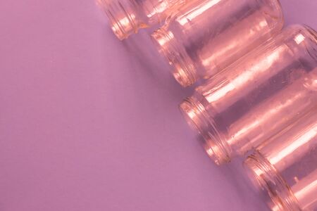 4 several pink jars on an isolated pink background with copyspace or blank empty room space for text or copy.の写真素材