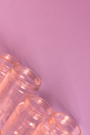 4 several pink jars on an isolated pink background with copyspace or blank empty room space for text or copy.の写真素材
