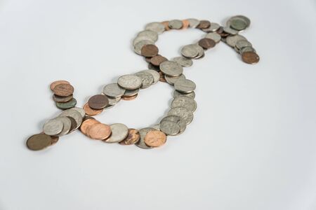 Dollar symbol of US American currency money coins in change - wealth economy / power status showing finance concept on blank white background with empty room space for copy, text or copyspace.の写真素材