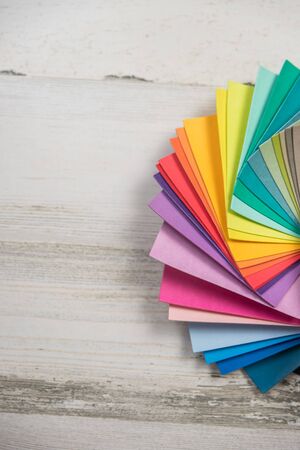 Colorful stack of sample test swatches for paint or fabric in spectrum rainbow colors with blank empty room space for text or copy.の写真素材