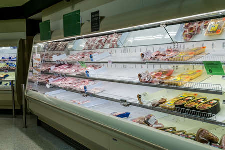 Atlanta, GA / USA - 04/02/20: A guy checking out the meat section at Publix where most poultry/ chicken is out of stock due to high demand and stockpile hoarding.のeditorial素材