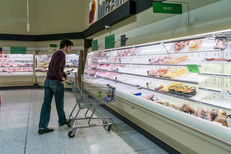 Atlanta, GA / USA - 04/02/20: A guy checking out the meat section at Publix where most poultry/ chicken is out of stock due to high demand and stockpile hoarding.のeditorial素材