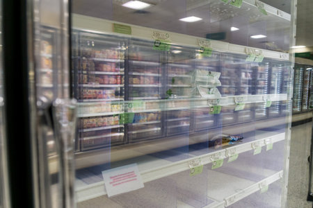 Atlanta, GA / USA - 04/02/20: Empty freezer shelves at Publix featuring frozen food shortage including organic vegetables, pizza, and junk food during Covid-19 corona virus.のeditorial素材