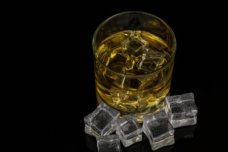 Whiskey in the rocks, Glass of whiskey with ice cubesのeditorial素材