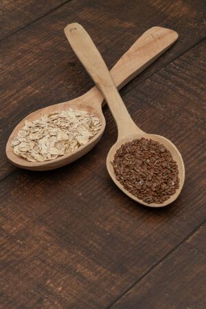 Seeds on a wooden spoon close upの写真素材