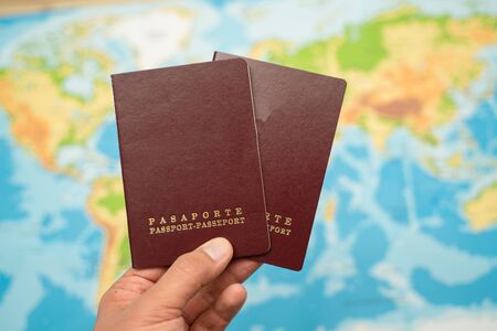 Man holds with his hand the Passport, world map. Travel conceptの写真素材