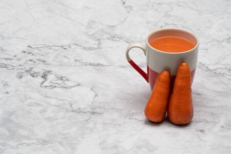 Glasses of carrot juice with vegetables on table close upの写真素材