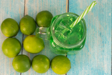 Lemonade summer cold drink with wooden background