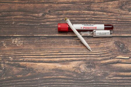 COVID 19 Coronavirus, Infected blood sample in the sample tube, Vaccine and syringe injection, Marijuana cannabis Medicinal It use for prevention treatment from COVID-19の写真素材