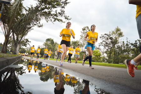 Bogota Colombia. (May 06, 2018). Participants in the race for 10K Heroes go trotting beside a puddle.のeditorial素材