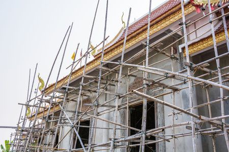 Construction of a temple building, the worker will stand on the scaffolding for working の写真素材