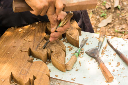 Hands woodcarver while working with the toolsの写真素材